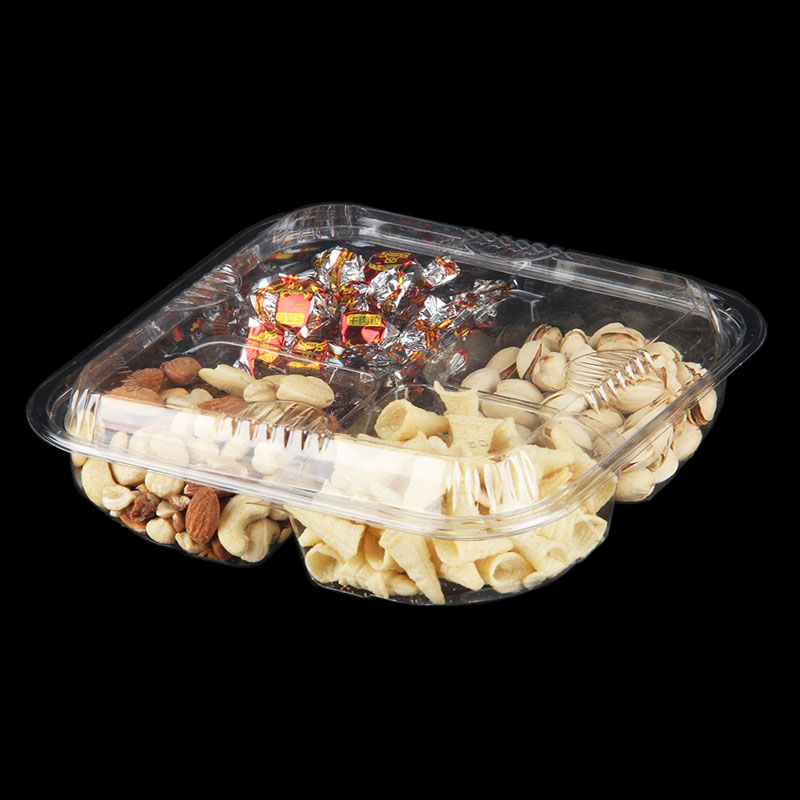 Clear plastic clamshell food containers on a prep line