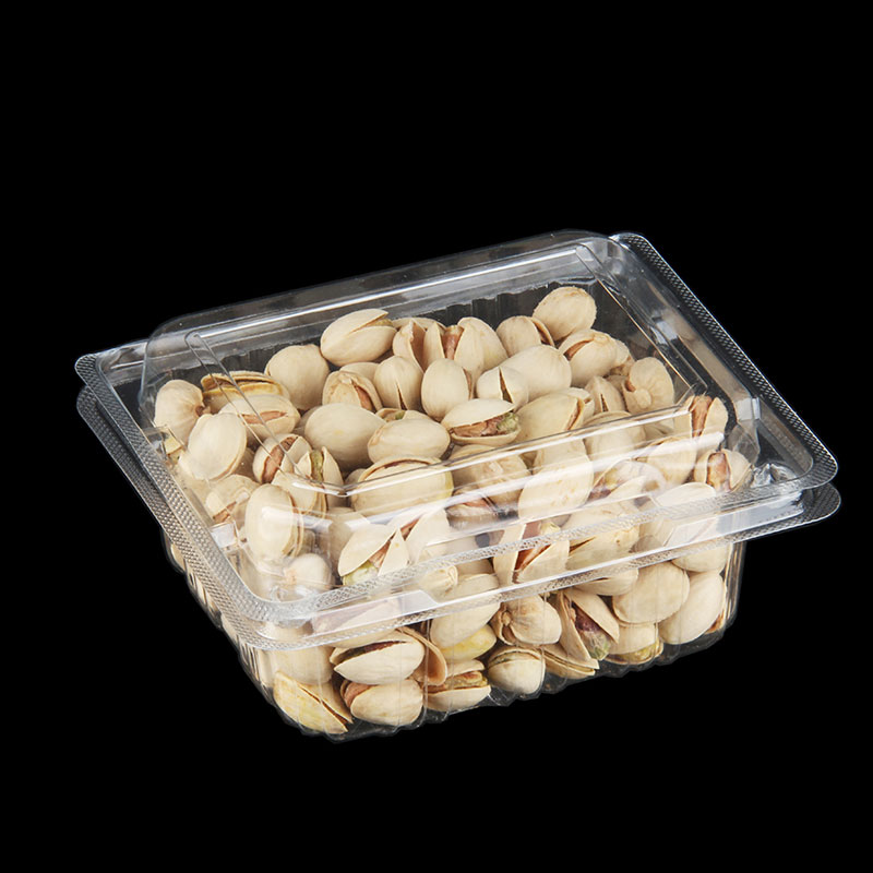 Transparent PET fruit packaging container displaying fresh produce on retail shelf