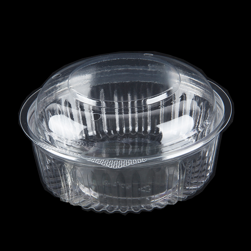 Clear flip top dessert container displaying food-safe structural integrity on a prep counter